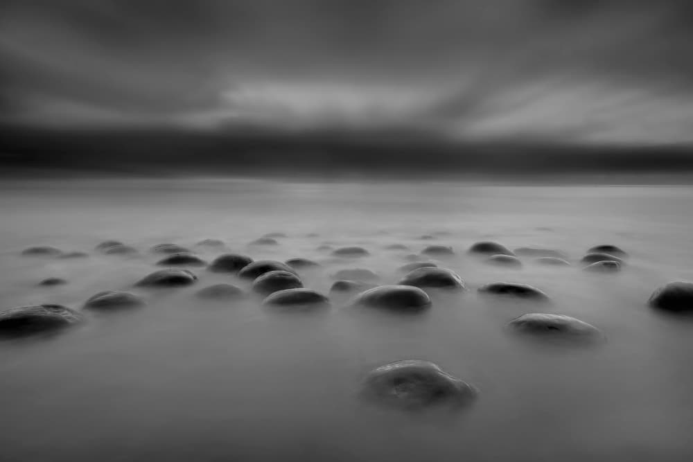 Moody Shoreline Rocks by Annie Poreider — canvas wall art