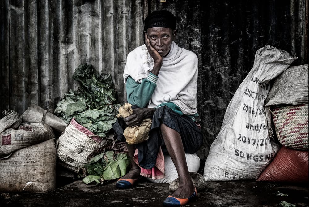 Pensive Market Vendor by Joxe Inazio Kuesta Garmendia — canvas wall art