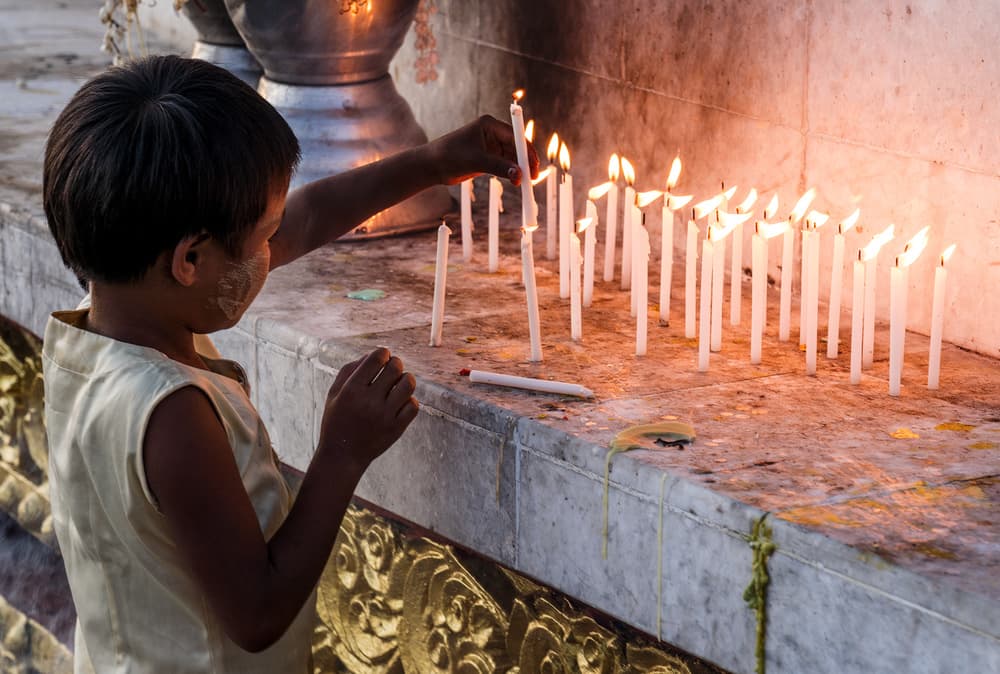 Child Lighting Temple Candles by Karsten Wrobel — canvas wall art