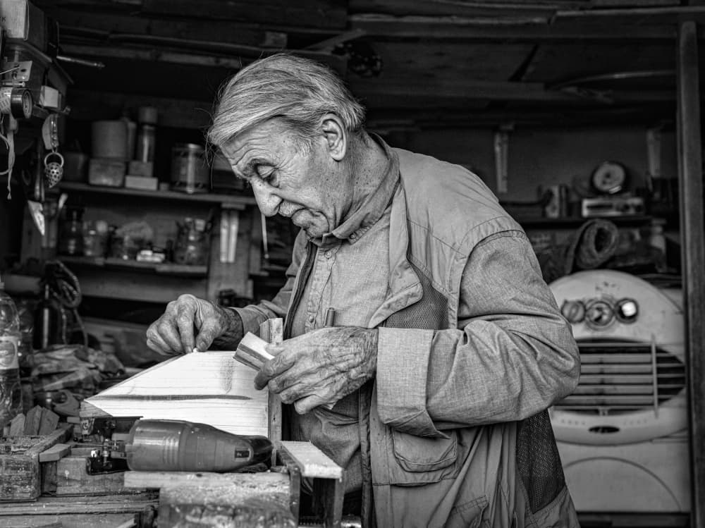 Skilled Hands Crafting Wood by Bashar Alsofey — canvas wall art