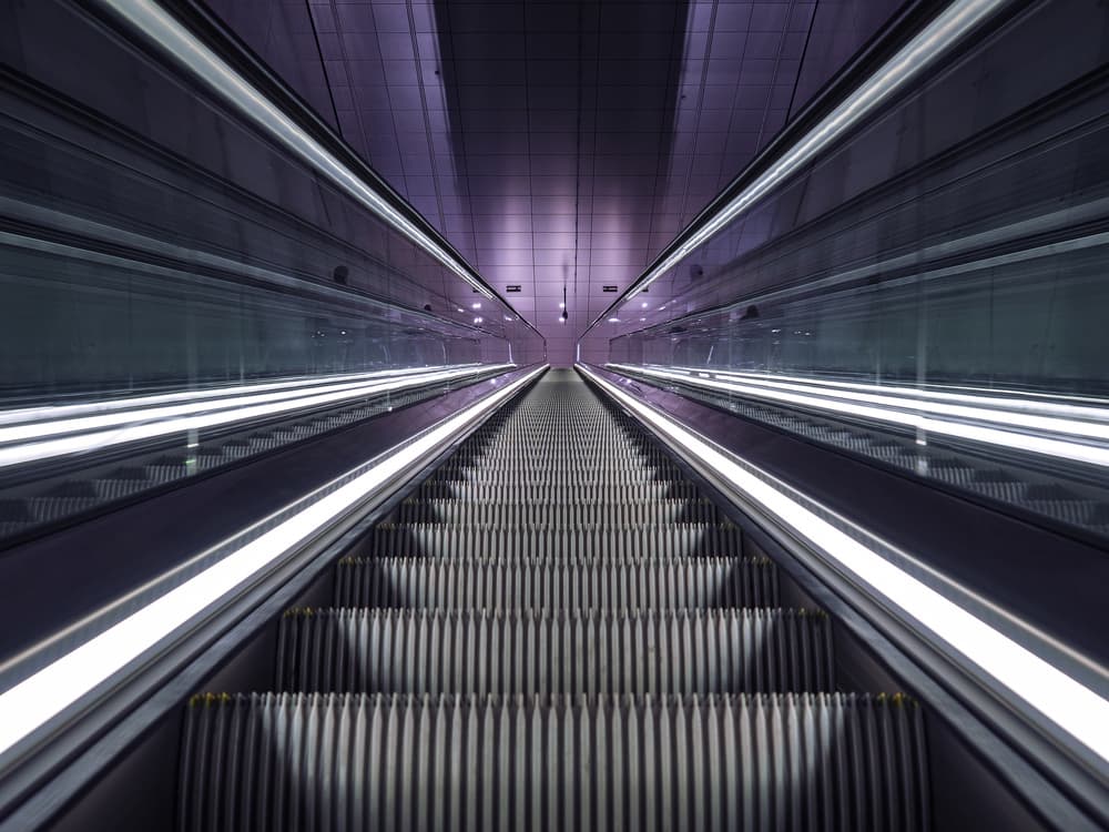 Illuminated Escalator Tunnel by Jaap Koer — canvas wall art