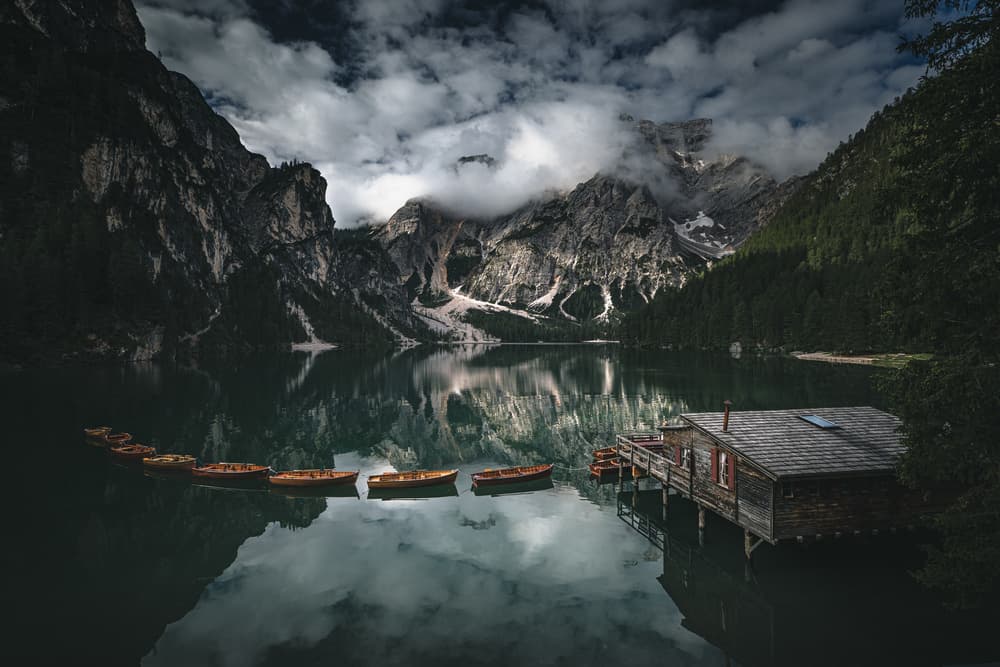 Boats on Moody Mountain Lake by Marco Tagliarino — canvas wall art