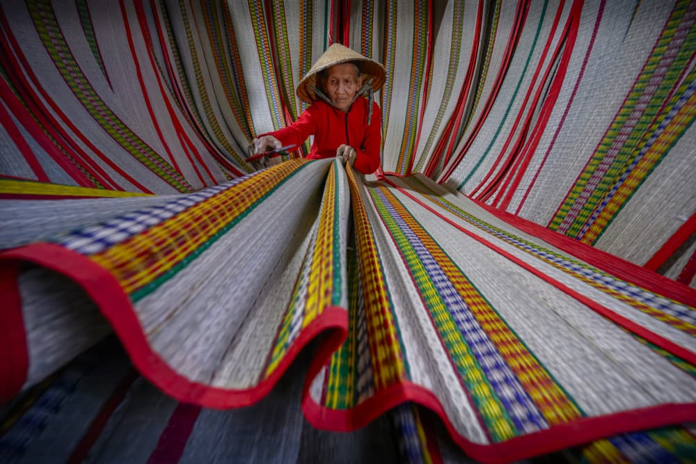 Artisan Weaving Colorful Mats by Joseph Ng — canvas wall art