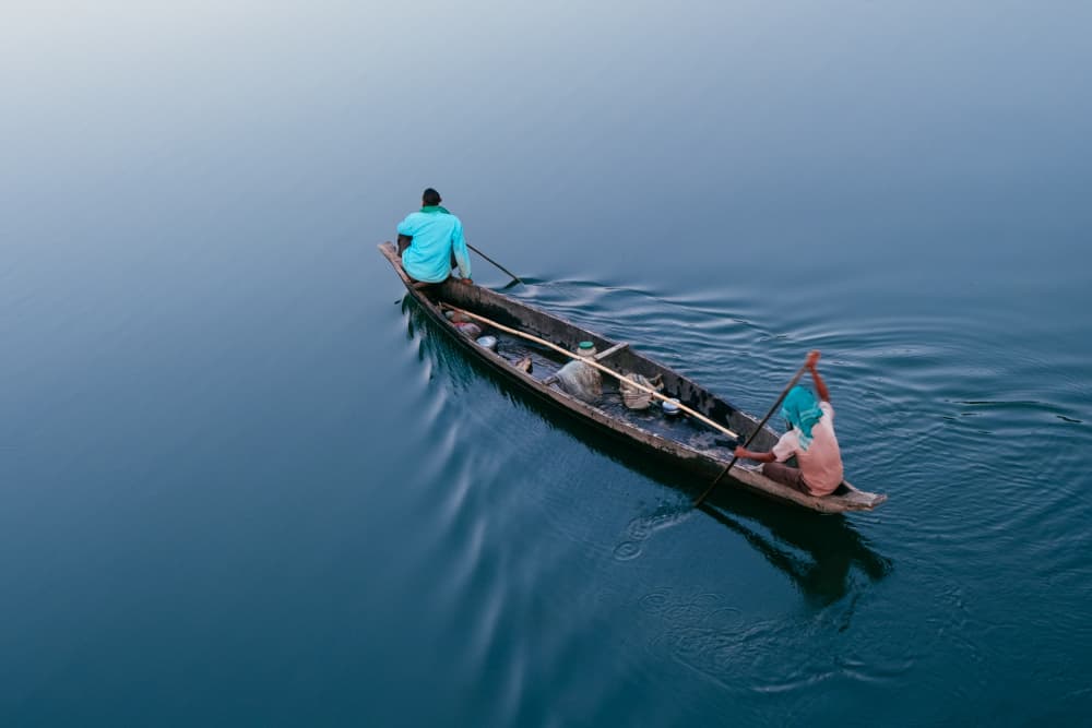 Serene Boat Journey by Dahlia Ambrose — canvas wall art