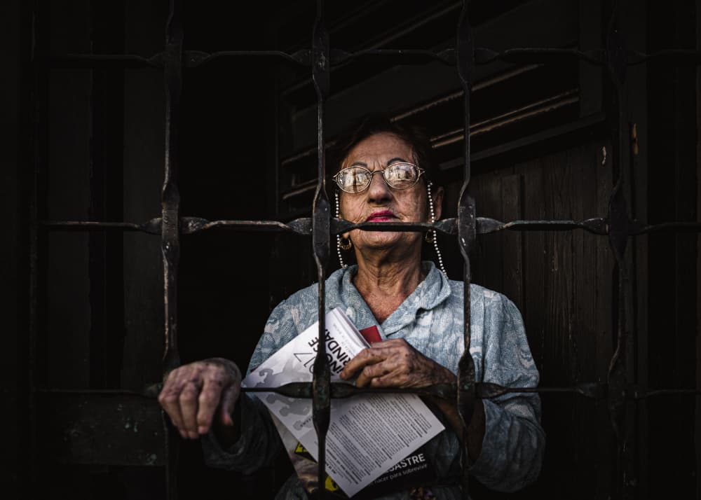 Thoughtful Gaze Behind Bars by Marco Tagliarino — canvas wall art
