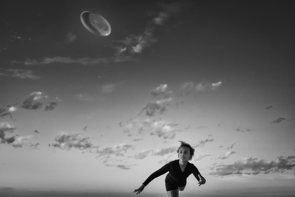 Focused Frisbee Catch by Gloria Salgado Gispert — canvas wall art