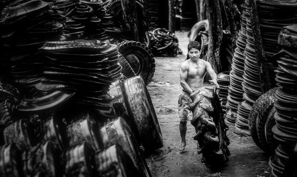 Gritty Tire Worker by Nguyen Tan Tuan — canvas wall art