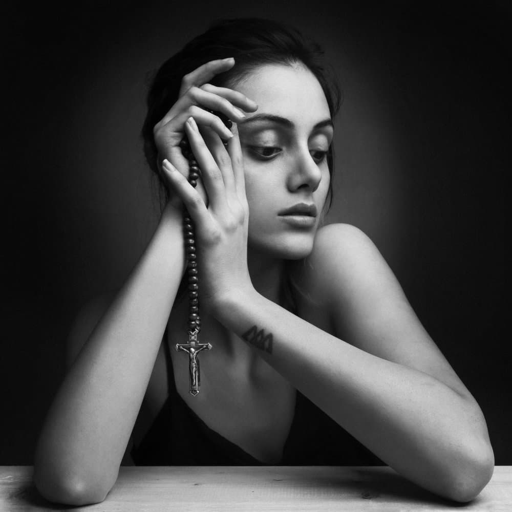 Pensive Woman With Rosary by behnamkhoramshahi — canvas wall art