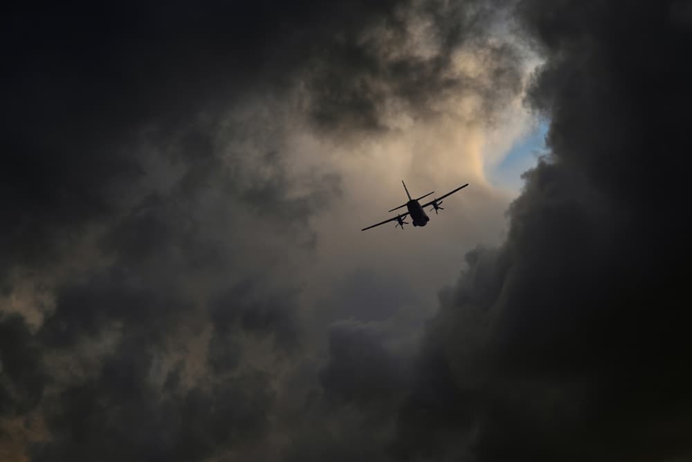 Plane Through Storm Clouds by Claudio Moretti — canvas wall art