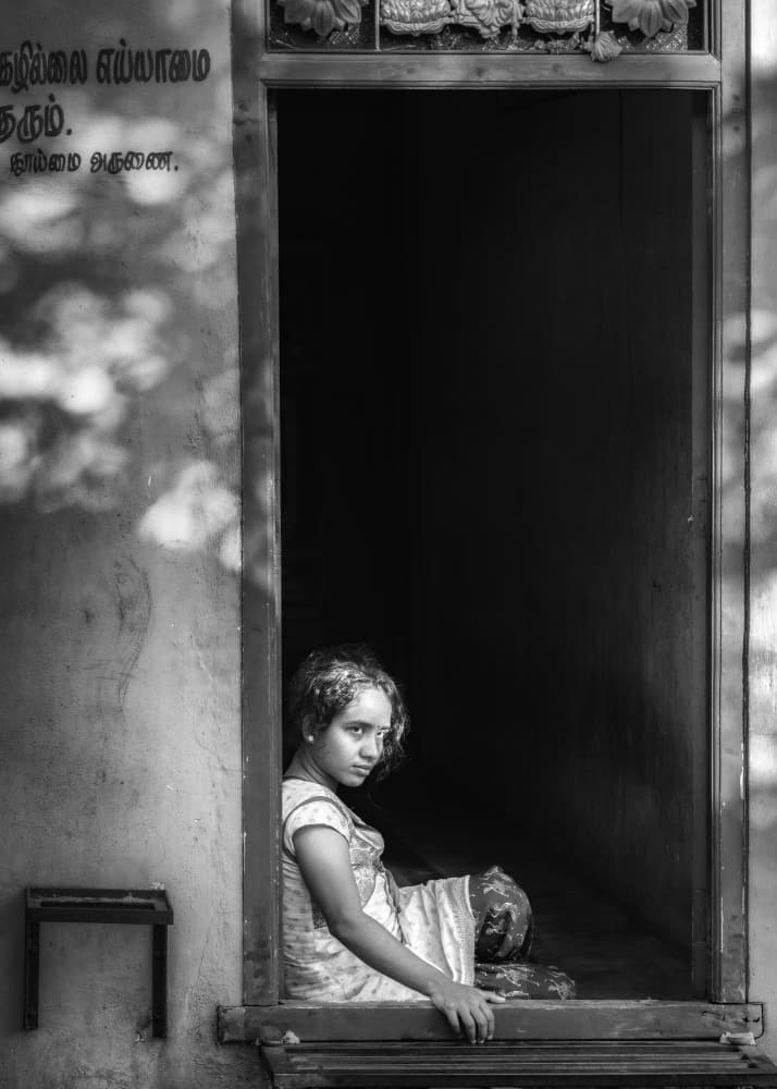 Pensive Girl in Doorway by Ludwig Riml — canvas wall art