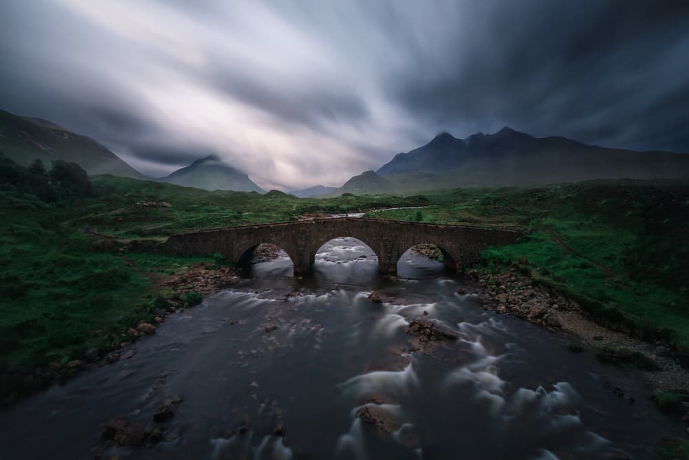 Moody Mountain River Bridge by Juan Pablo de Miguel — canvas wall art