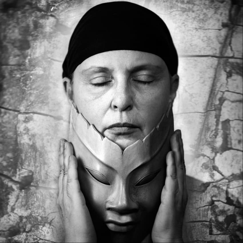 Serene Woman Holding Mask by Angelika Martha Himburg — canvas wall art