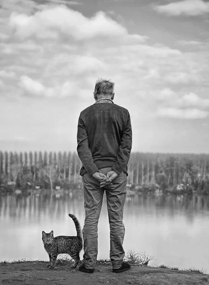 Contemplative Man And Cat by Miodrag Kosanovic — canvas wall art