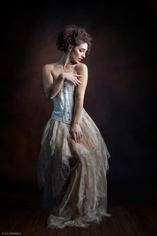 Pensive Woman In Corset by Luc Stalmans — canvas wall art