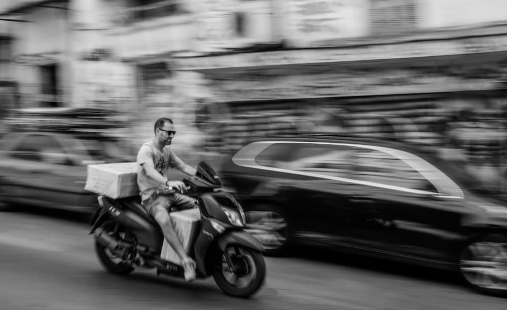 Man On Scooter In Motion by Itzik Einhorn — canvas wall art