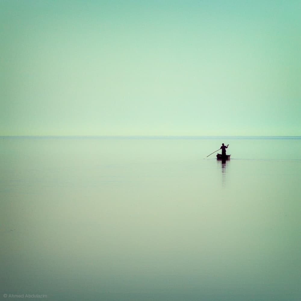 Lone Boat on Calm Water by Ahmed Abdulazim — canvas wall art