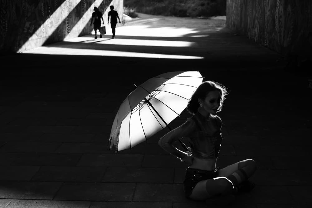 Woman Umbrella Dramatic Light by Josefina Melo — canvas wall art