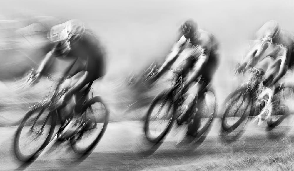Blurred Cyclists Racing by Lou Urlings — canvas wall art