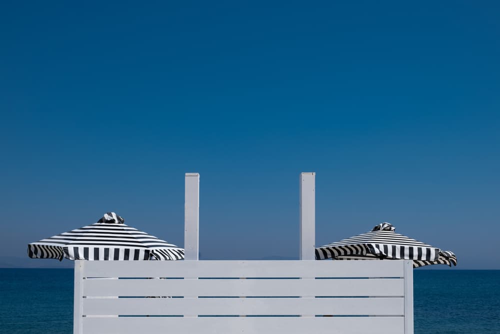 Striped Umbrellas Blue Horizon by Rolf Endermann — canvas wall art