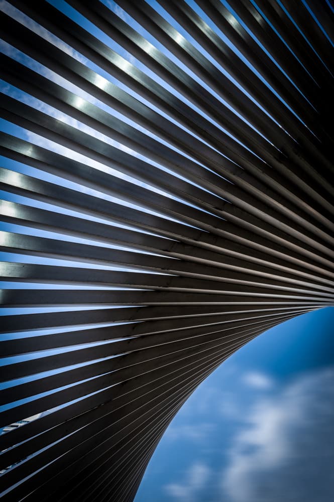 Curved Metal Lines Sky by Jean Vandijck — canvas wall art