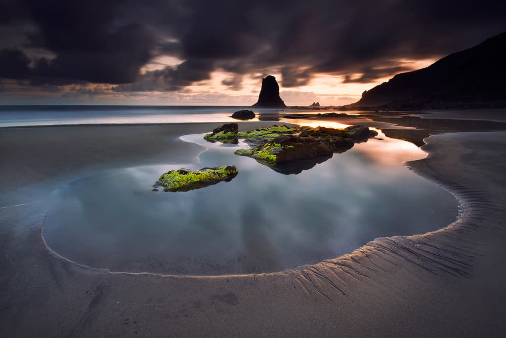 Moody Beach Reflections by Carlos M. Almagro — canvas wall art