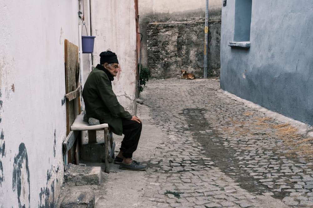 Old Man on Cobblestone Street by Ali Ayer — canvas wall art