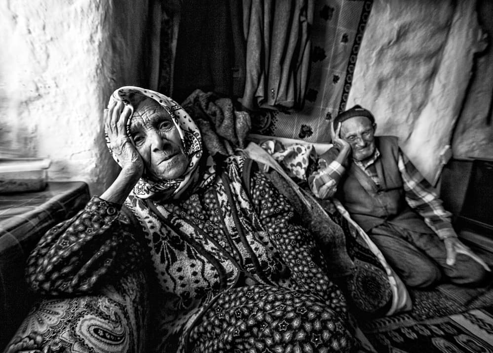 Pensive Old Couple by Feyzullah Tunç — canvas wall art