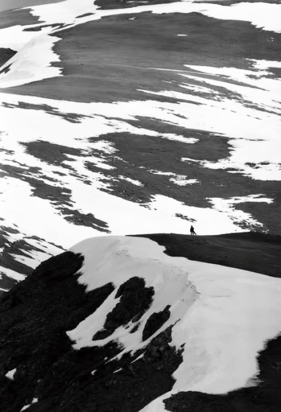 Solitary Hiker Snowy Mountain by Cristian Flueraru — canvas wall art