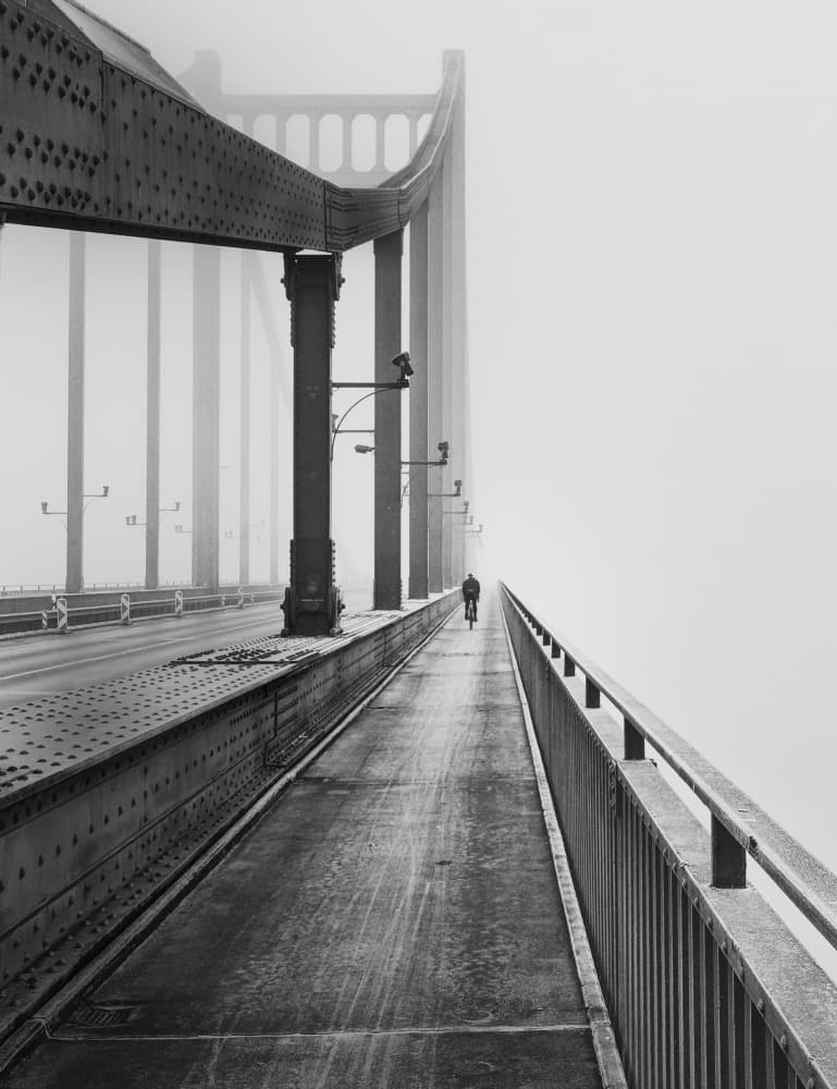 Cyclist on Foggy Bridge by Andreas Timar — canvas wall art