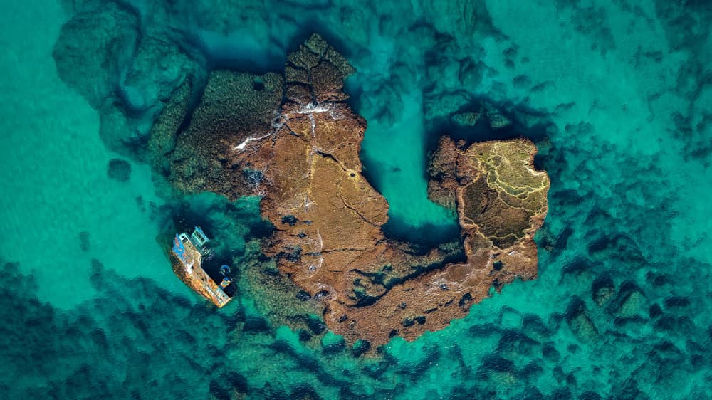 Shipwreck in Turquoise Waters by Ido Meirovich — canvas wall art