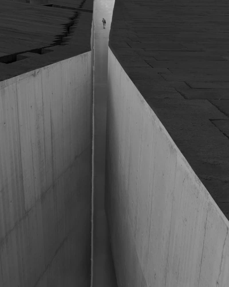 Lone Figure In Concrete Canyon by Olavo Azevedo — canvas wall art
