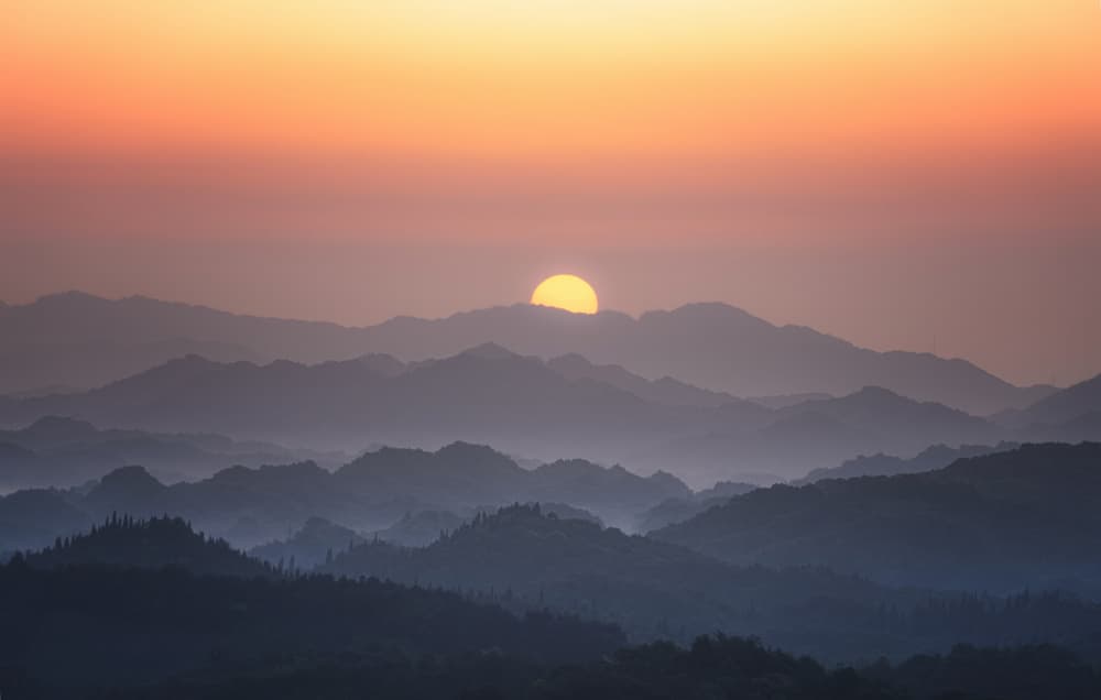 Hazy Mountain Sunset by Yezimao — canvas wall art