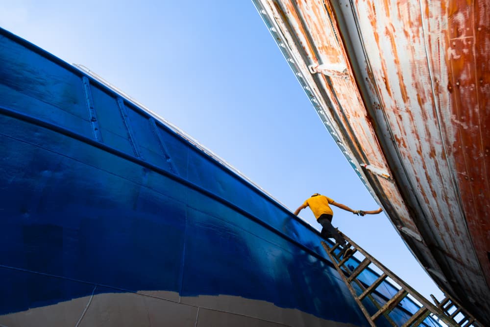 Worker Painting Ship Hulls by Alaa Nour — canvas wall art