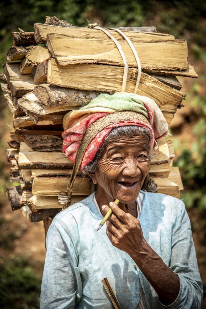 Happy Elder Carrying Wood by Eyal Alcalay — canvas wall art