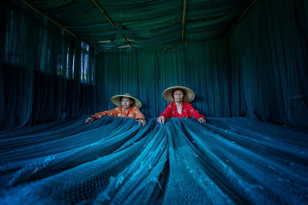 Women Weaving Fishing Nets by Mieke Suharini — canvas wall art