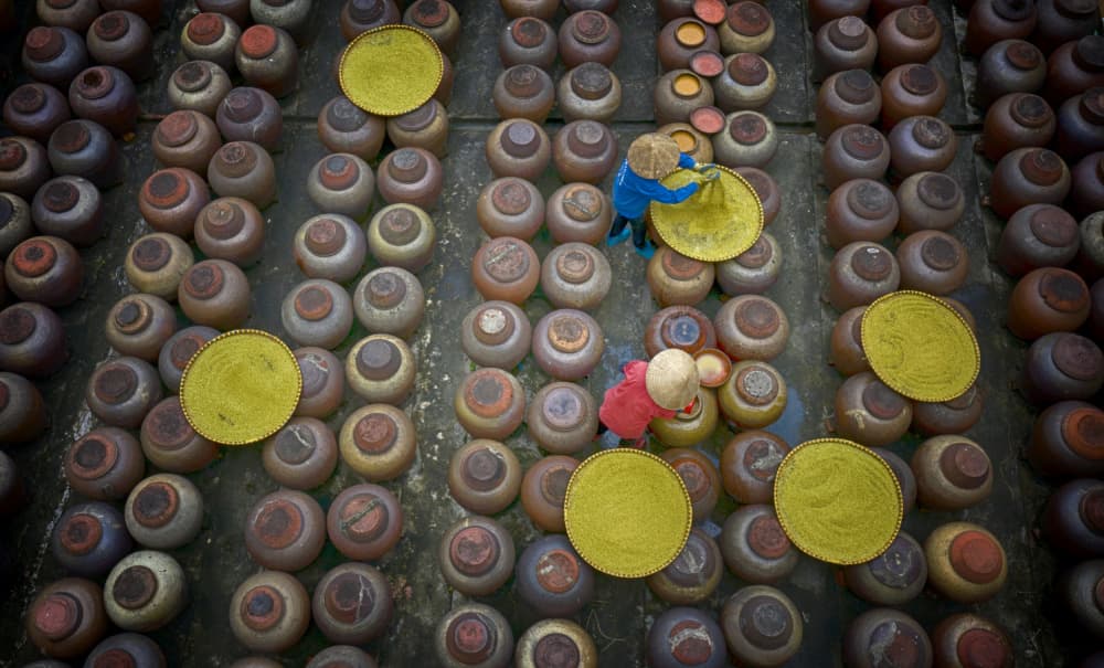 Women Working with Clay Jars by Angela Muliani Hartojo — canvas wall art
