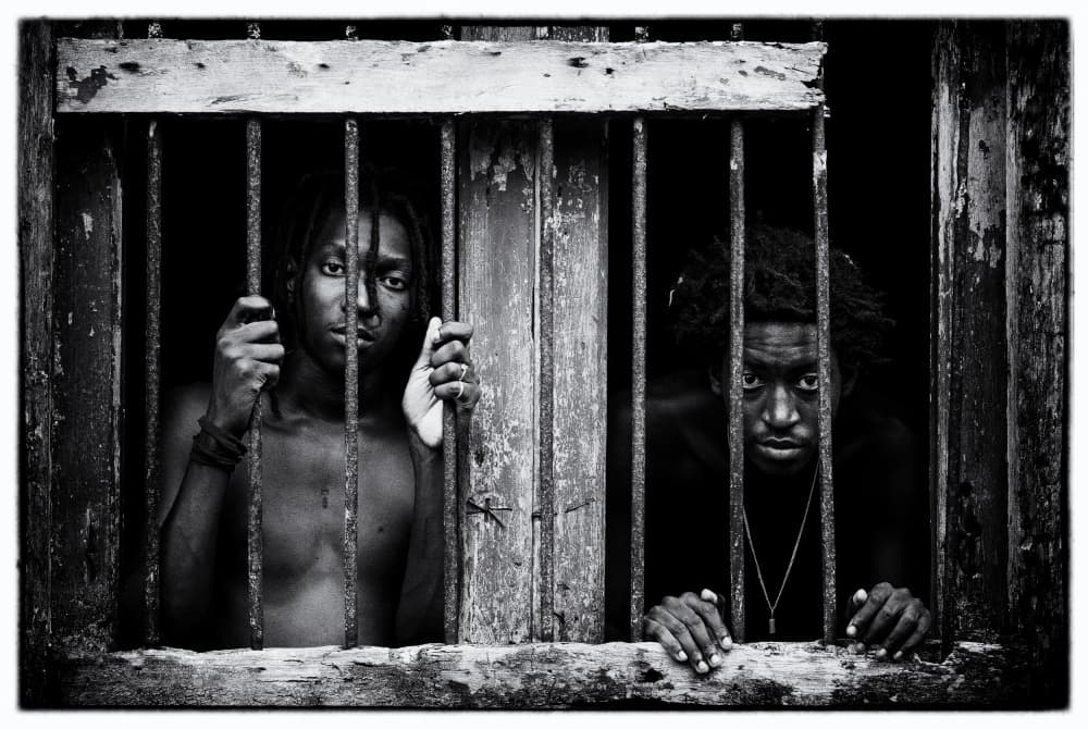 Youthful Gaze Behind Bars by Daniel Martínez — canvas wall art