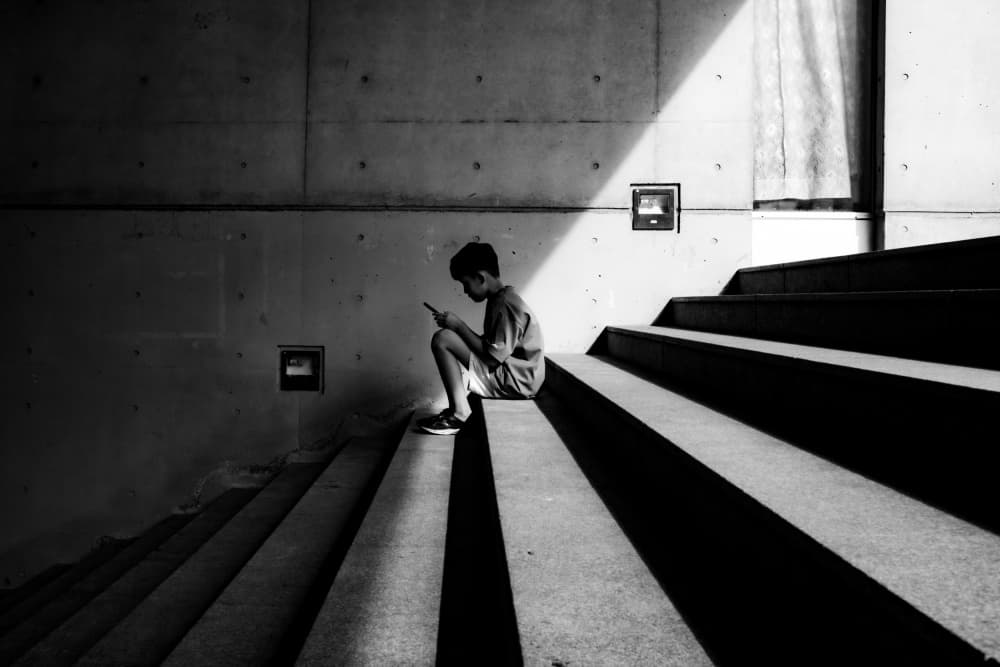 Young Boy on Concrete Steps by Yohei Kawashima — canvas wall art