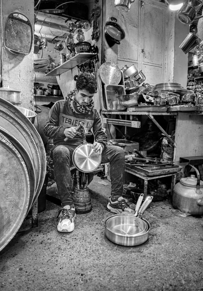 Artisan Working In Workshop by Bashar Alsofey — canvas wall art
