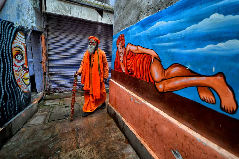 Sadhu in Vibrant Alley by Avishek Das — canvas wall art