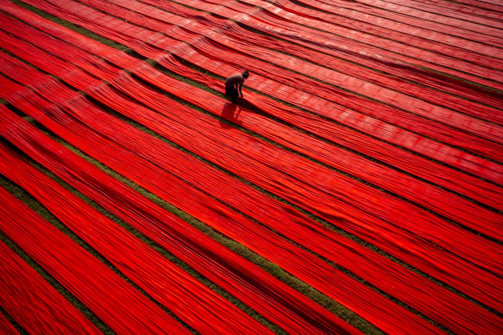 Red Fabric Worker by Azim Khan Ronnie — canvas wall art