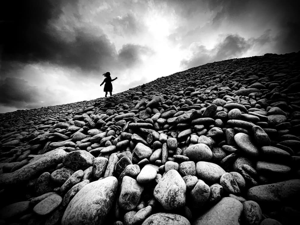 Child on Rocky Slope by Mirela Momanu — canvas wall art