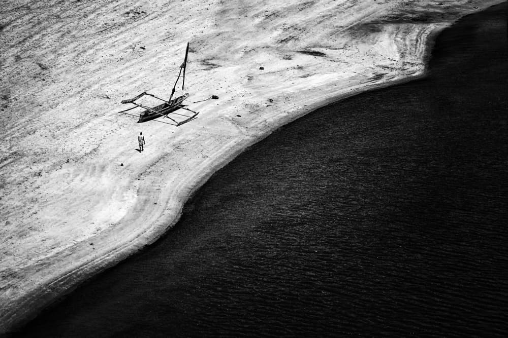 Lone Man Coastal Outrigger by Foad Mirzaie — canvas wall art