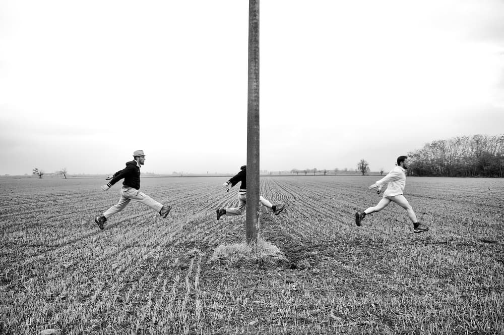 Men Leaping Around Pole by Carlo Ferrara — canvas wall art