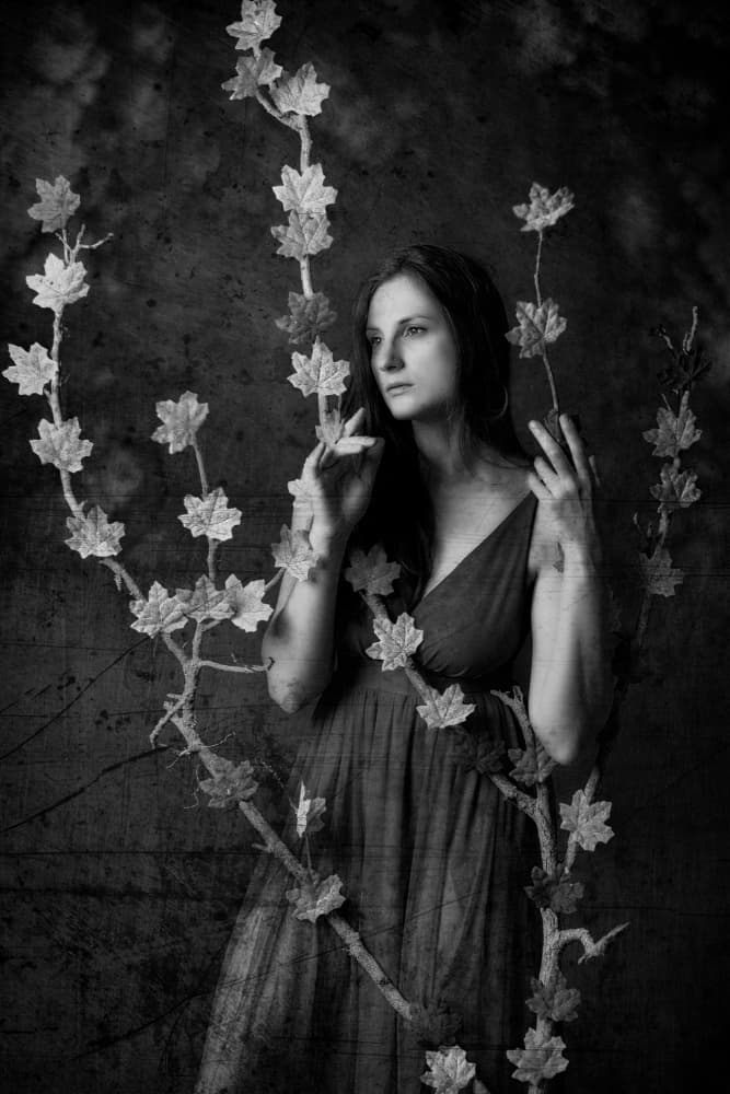 Serene Woman Among Leaves by Amnon Eichelberg — canvas wall art