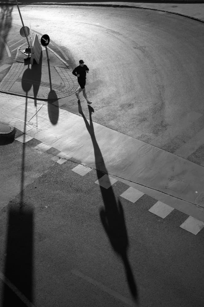 Urban Runner's Long Shadow by Tamas Dragon — canvas wall art