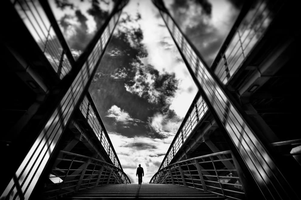 Lone Figure on Bridge by Eric Drigny — canvas wall art