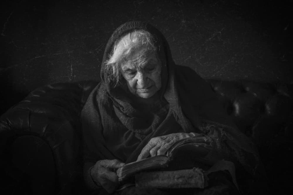 Pensive Old Woman Reading by Ramiz Sahin — canvas wall art