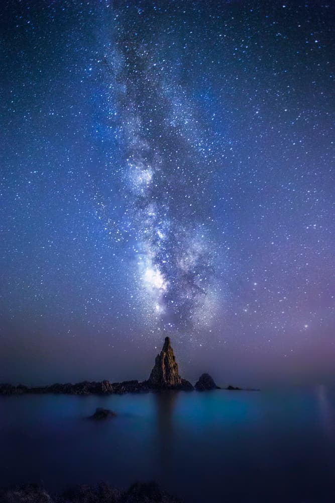 Milky Way Over Ocean Rocks by Jose Garcia — canvas wall art