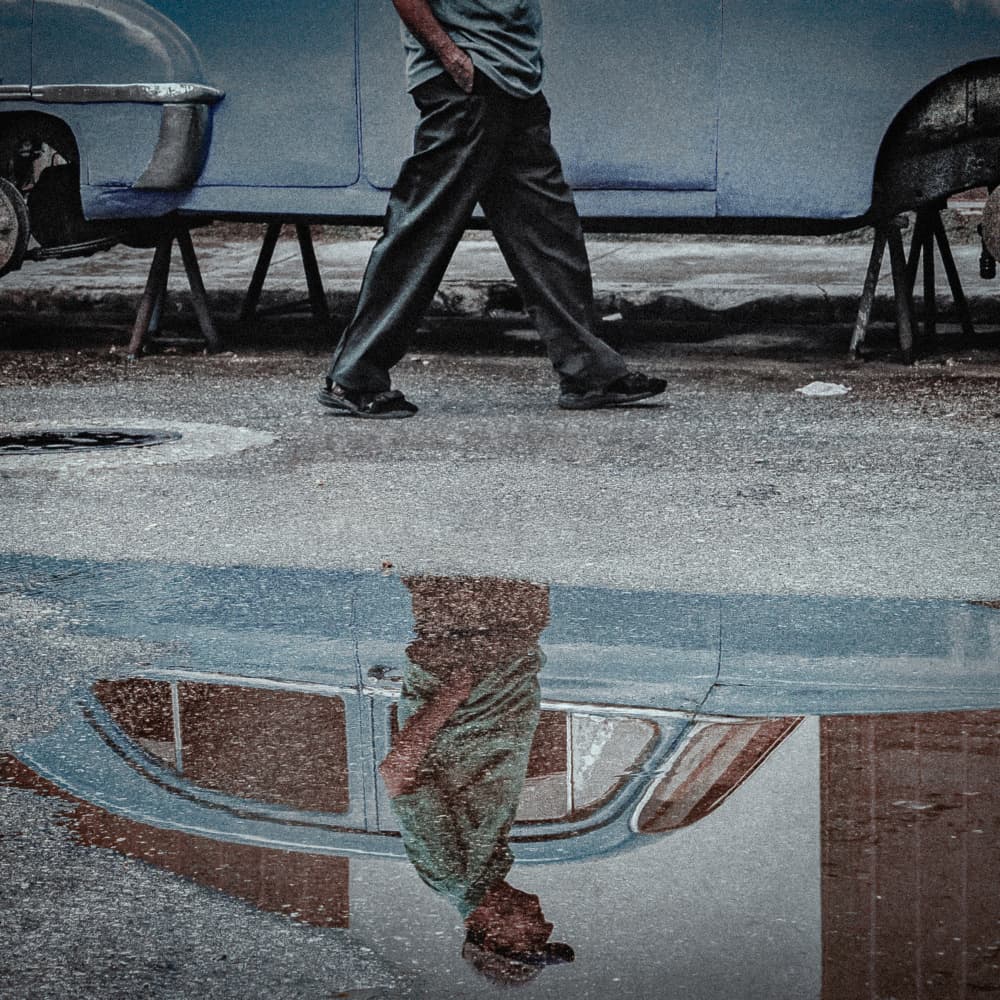 Man Walking Puddle Reflection by Andy Bauer — canvas wall art